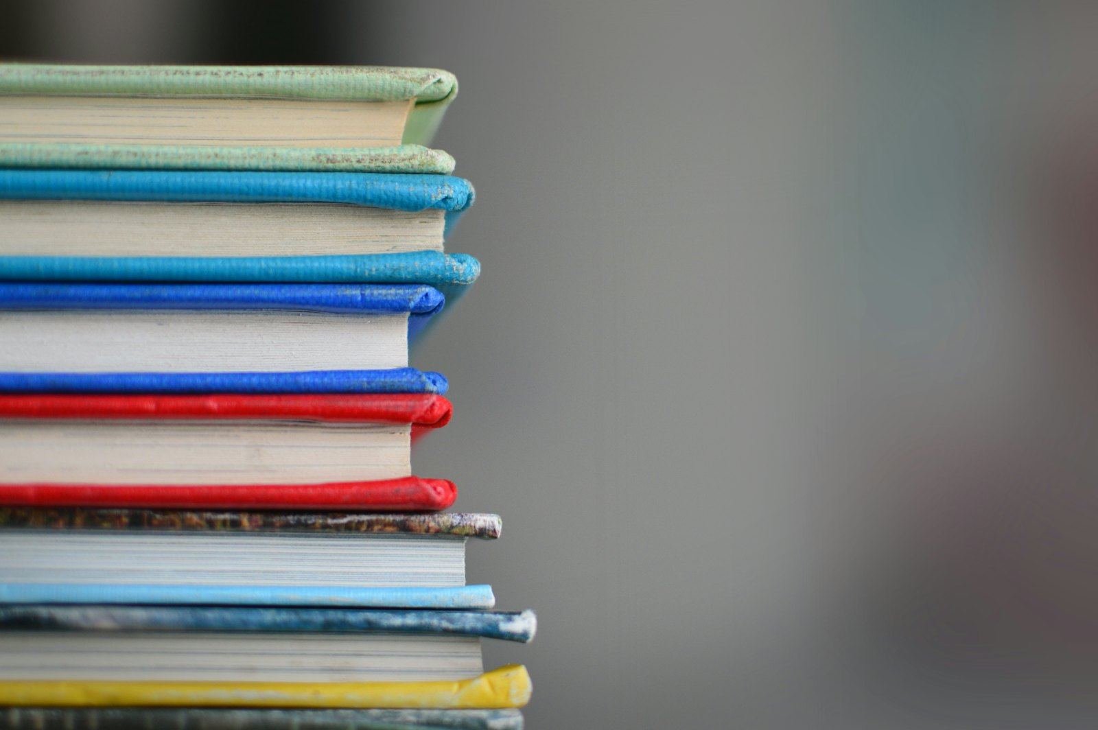A stack of colourful textbooks