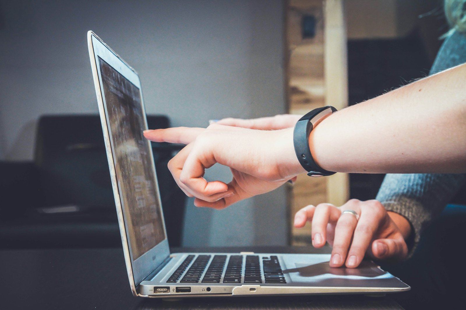 Hands using a laptop computer