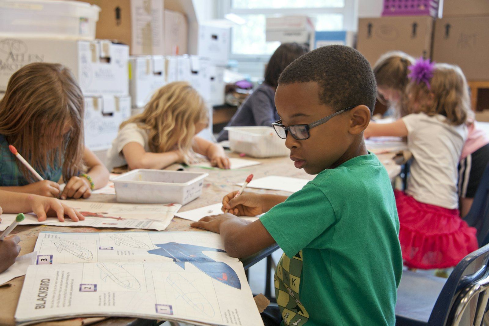 Young children drawing at a table
