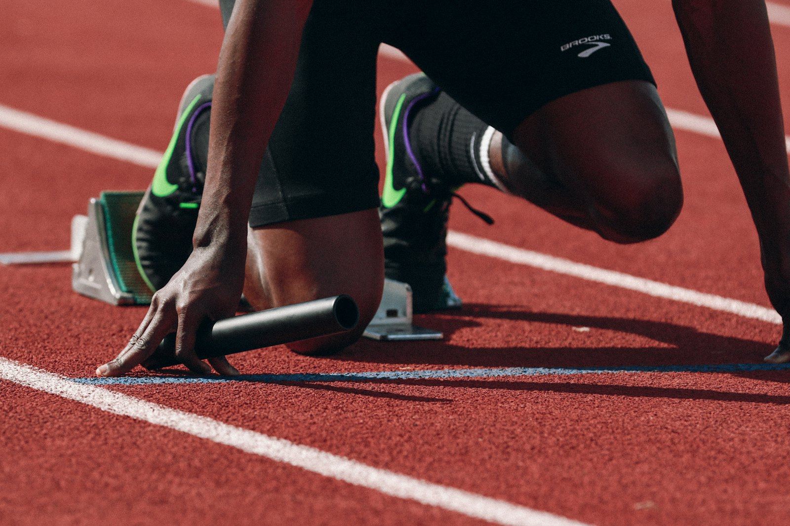 An athlete at the starting line of a running track